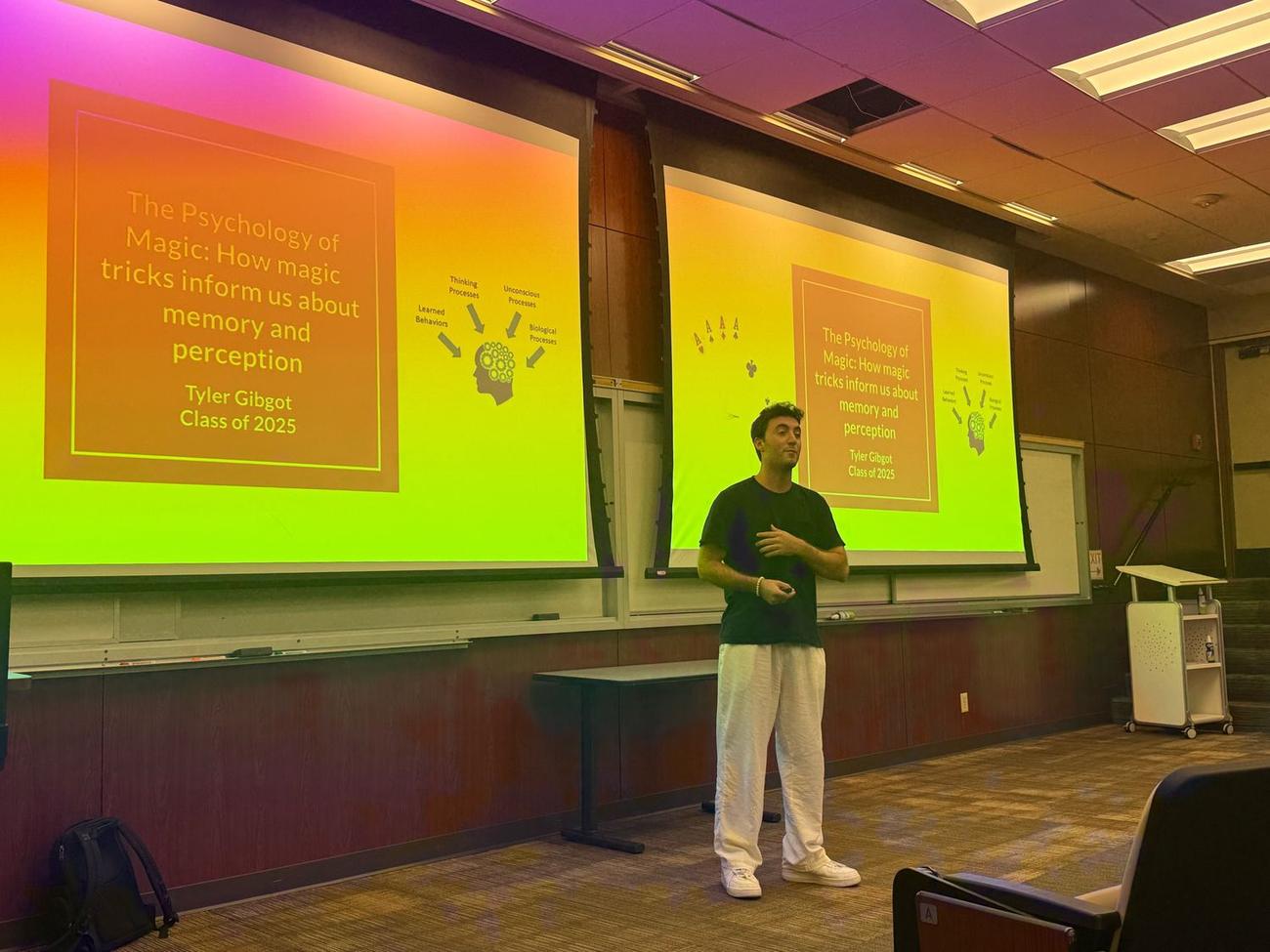 Tyler Gibgot lecturing at USC in front of slides titled The Psychology of Magic: How magic tricks inform us about memory and perception.