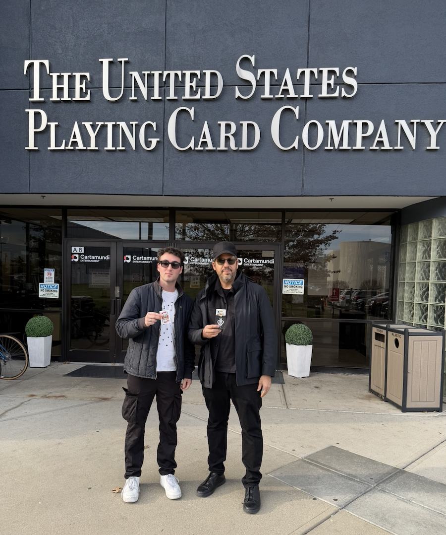 Tyler and David Blaine holding playing cards outside The United States Playing Card Company.